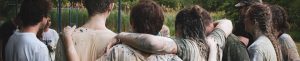 teens covered in mud in a group huddle