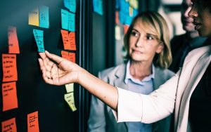 Women looking at to-do list on a whiteboard