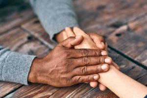 Two people holding hands