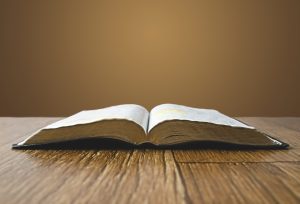 Open bible on wooden table