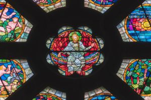 Rodunda of stained glass with Jesus in center